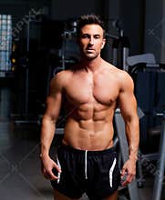 Fitness shaped muscle man posing on gym