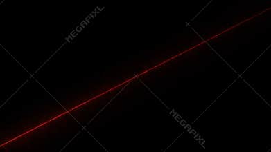 A red laser beam shines diagonally on a black background