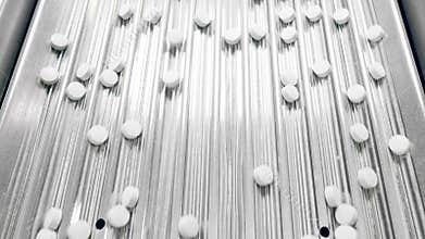 Lines of pills on the conveyor belt in a top view