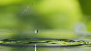 Water splash, slow motion. Water drop falls into