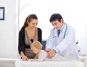 Cute baby being checked by a pediatric doctor