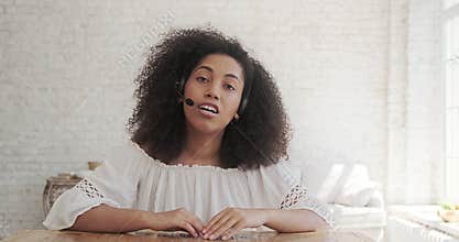 A black African businesswoman speaks to a web camera