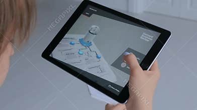 Woman using tablet with augmented reality app - robotized production module