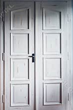 Vintage white double doors inside house. Classic wooden door