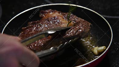 Person fries side part of beef steak