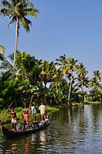 Village people carrying rocks in a boat, Kerala India.