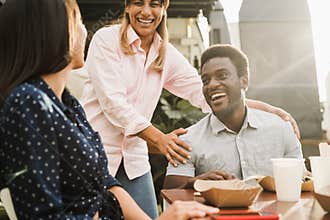 Diverse people eating at food truck restaurant outdoor - Soft focus on african american man face