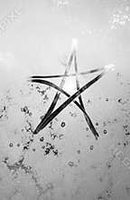 Star shine, winter frost, the inscription on the sweaty glass star and sun, black and white photography
