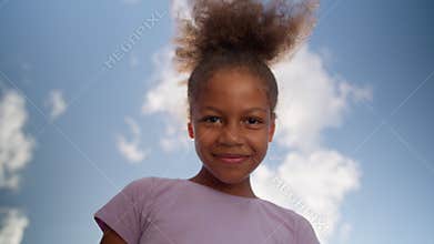 Bottom view little girl happy ethnic African American child curly schoolgirl preteen pupil school student studying