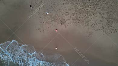 Portugal, whose drone shooting. Young people walking along the beach by the ocean