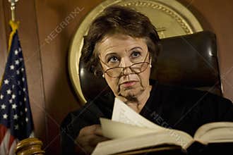 Judge With Book Looking Away In Court Room