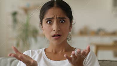 Portrait indoors shocked wonder amazed woman stunned puzzled confused Indian girl anxiety worried female Arabian lady at