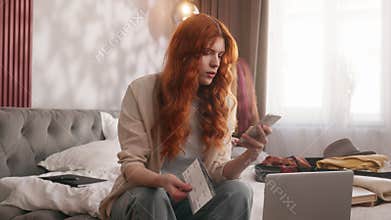 Confused traveler woman at bedroom trying booking hotel airline laptop flight cancel problem calling support service