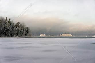 Snow-covered forests on islands in warm light