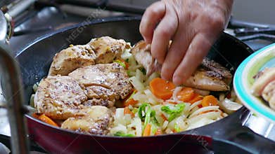 Close-Up of the Hands of a Latin Woman Stir-Frying Vegetables and Adding Chicken Breasts in a Cooking Pan for Meal
