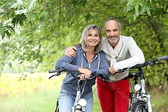 Senior couple ready for riding bicycle