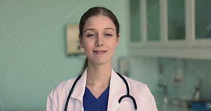 Headshot of happy woman cardiologist posing at workplace