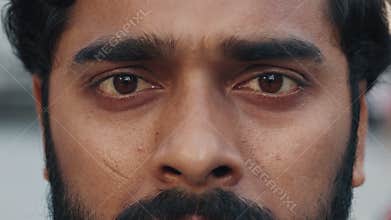 Close up brown eyes of brunette man with determined look