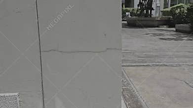 building with cracked concrete and walls, particularly at the corners of the outside cement columns