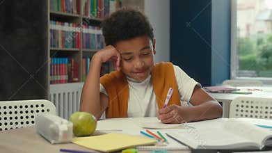 School classroom studying African American kid little boy son schoolboy pupil learner student tired sleepy child yawning