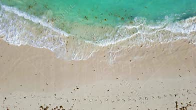 Areal view of Caribbean shoreline, With Turquoise water hitting the sandy beach