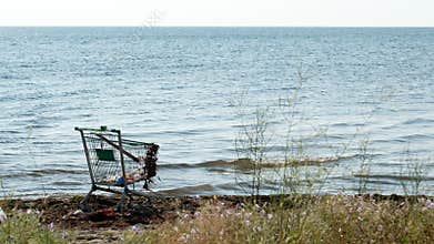 Abandoned shopping trolley on the beach
