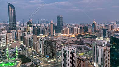Modern city architecture of Abu Dhabi skyline day to night timelapse, UAE.