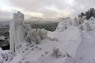 Natural ice sculptures on a dark shoreline