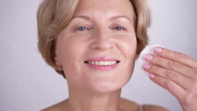 Charming lady removing makeup