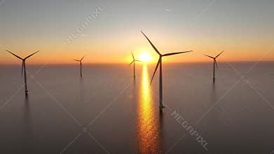Offshore wind farm in the sea at sunrise or sunset. Aerial view of Windpark with wind turbines