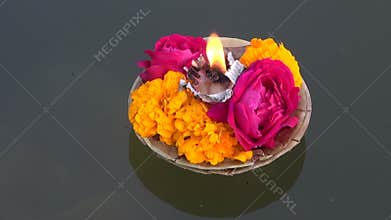 Hinduism religious ceremony puja flowers and candle on Ganges, India