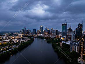 Austin, Texas skyline shining on the waters of Colorado River, creating a breathtaking view as night falls under a