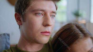 Sad man bonding girlfriend watching movie at sofa closeup. Couple looking tv