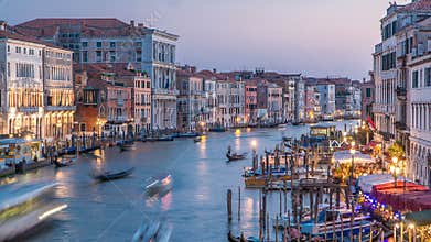 Grand Canal in Venice, Italy day to night timelapse. Gondolas and city lights from Rialto Bridge.