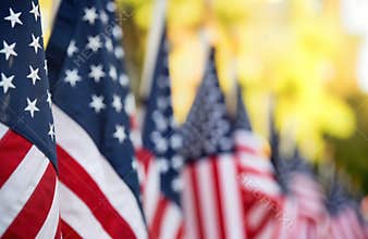 American flags in row. Closeup view of multiple US flags. Patriotic display for Memorial Day Independence Day. Sunny outdoor