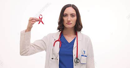 Woman doctor holds red ribbon indicating world AIDS day