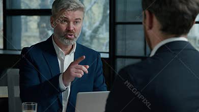 Serious Caucasian man consultant businessman consulting client business job interview in office employer hr manager