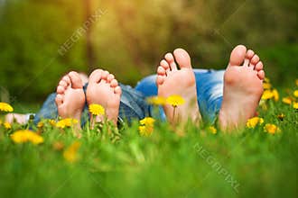 Feet on grass. Family picnic in spring park