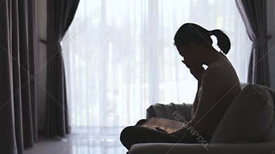 Silhouette of Woman suffering from depression lies on the sofa , has stress, anxiety, sickness and headaches, life problems,