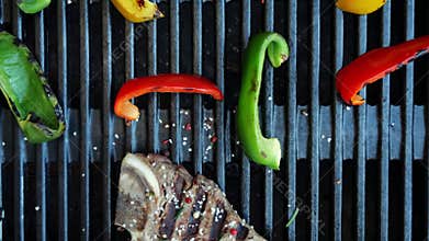 T- bone beef steak grill with vegetables on a cast iron barbecue. Top view