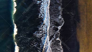 Black sand beach with crashing waves, Serene and tranquil landscape, Ocean coast with calm waves, Famous landmark of