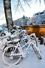 Bicycles covered in snow