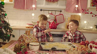 Cute boys dancing on the kitchen on Christmas Eve