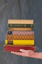 female hand and a stack of books,education,knowledge,library,back to school concept,free copy space
