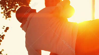 Family walks in the countryside during sunset. Love, parental care and children concept. Vertical.