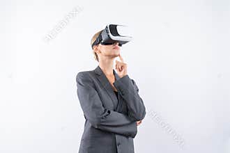 Smart businesswoman thinking about plan while wearing VR glasses. Contraption.