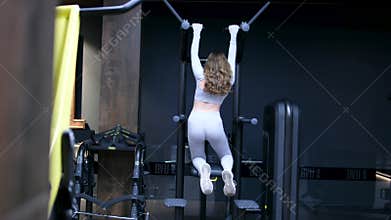 Woman doing pull-up. Strong girl in sportswear doing pull up exercise. Be H3althy