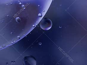 The oil stains floating on the surface of the water are blue and reminiscent of an alien galaxy. 24.05.2024 Szirákon, Hungary.