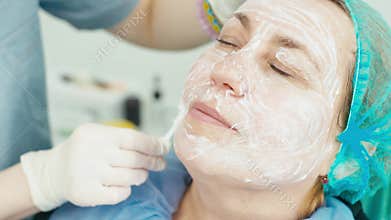 Close-up of applying anesthesia to the skin of the face.