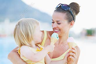 Smeared mother and baby eating ice cream